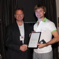 OutSport Toronto Chair Shawn Sheridan presenting Konstantin with framed letter of appreciation