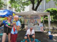 Hot enough?: Downtown Swim Club members cooling off passers-by with a bit of water in front of their booth.